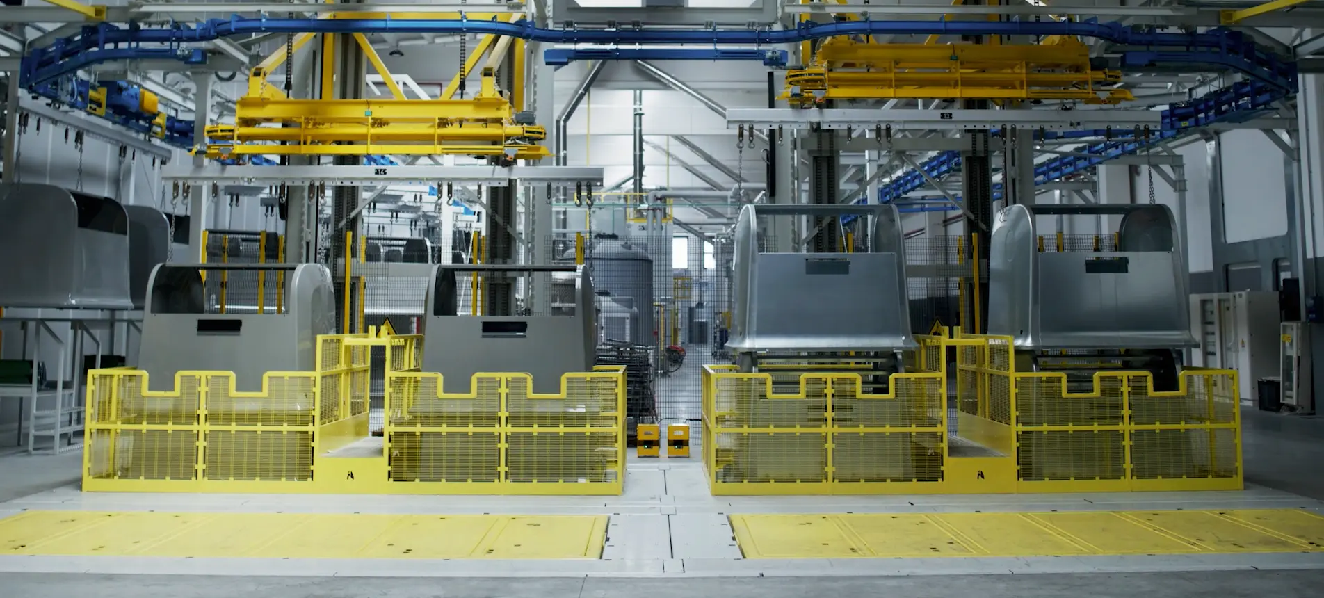 Nord Engineering production line with containers and yellow safety cages
