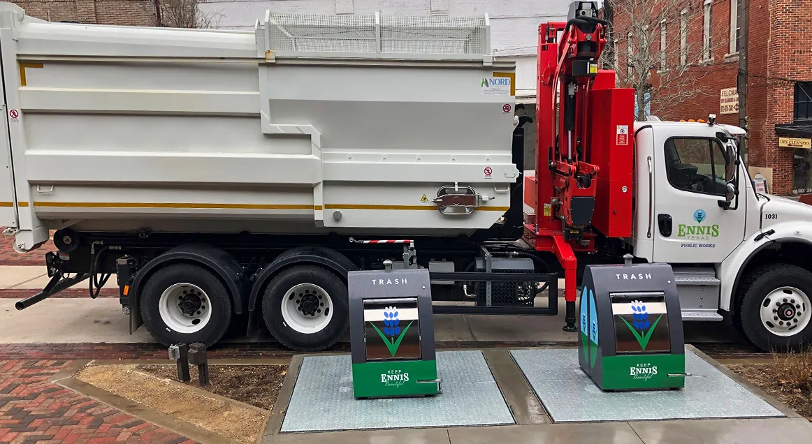 Easy System truck next to underground containers in Ennis, Texas