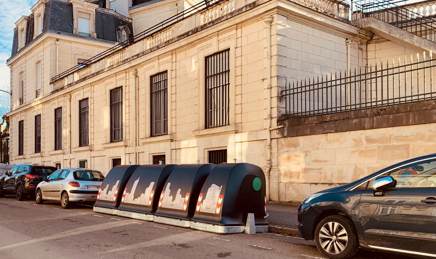 City Next containers along a street of historic buildings